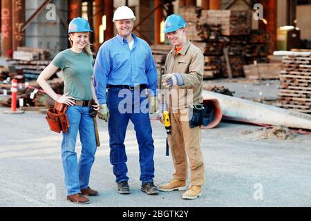 group of construction workers looking at camera on construction site Stock Photo