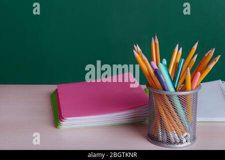 School supplies on table on board background Stock Photo