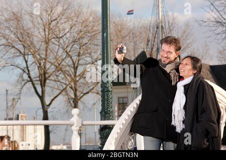 Mature couple taking selfie in Middelburg on a short vaccation Stock Photo