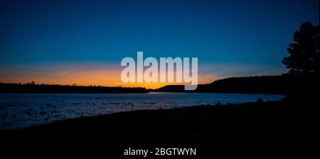 Deep blue sunset over a mountain lake Stock Photo