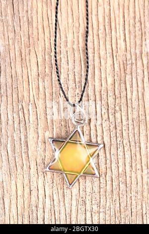 Star David pendant on wooden background Stock Photo