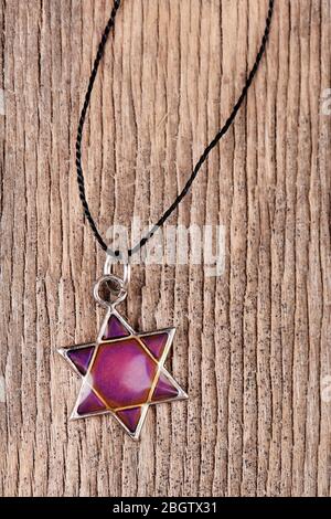 Star David pendant on wooden background Stock Photo