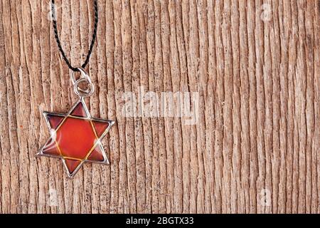 Star David pendant on wooden background Stock Photo