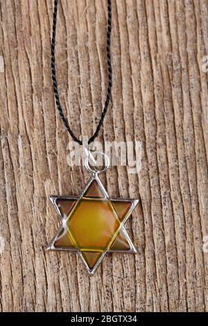 Star David pendant on wooden background Stock Photo