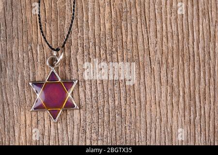 Star David pendant on wooden background Stock Photo