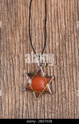 Star David pendant on wooden background Stock Photo