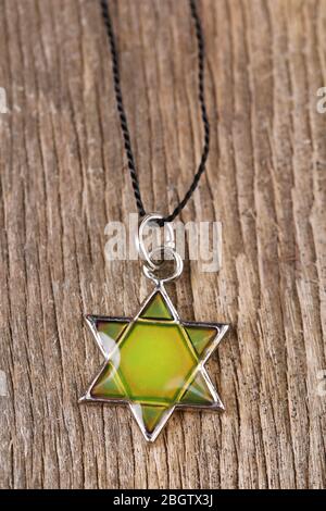 Star David pendant on wooden background Stock Photo