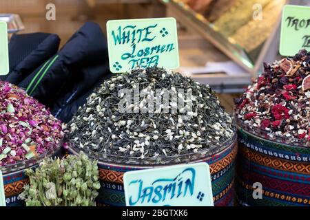 Dried herbal teas close-up. In the round box in front of the store. Healthy and delicious in different varieties and flavors. Stock Photo