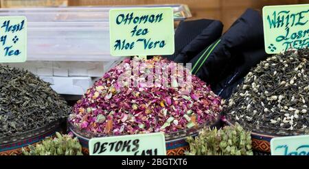 Dried herbal teas close-up. In the round box in front of the store. Healthy and delicious in different varieties and flavors. Stock Photo