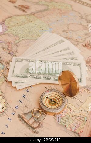 Compass with a bundle of big money are on the map Stock Photo