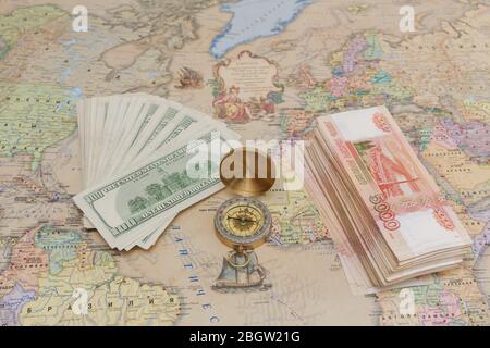 Compass with a bundle of big money are on the map Stock Photo