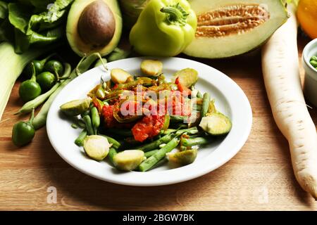 Healthy salad with peas and asparagus served on wooden table, close-up Stock Photo