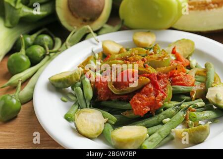 Healthy salad with peas and asparagus served on wooden table, close-up Stock Photo