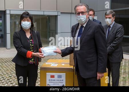 Athens, Greece. 22nd Apr, 2020. Chinese Ambassador to Greece Zhang Qiyue (L) and Greek Alternate Migration and Asylum Minister Giorgos Koumoutsakos (R, front) pose for a photo at the donation handover ceremony in Athens, Greece, on April 22, 2020. Greece welcomed on Wednesday the donation by China to help curb the spread of the novel coronavirus at hosting facilities, where thousands of refugees and migrants are accommodated. Credit: Marios Lolos/Xinhua/Alamy Live News Stock Photo