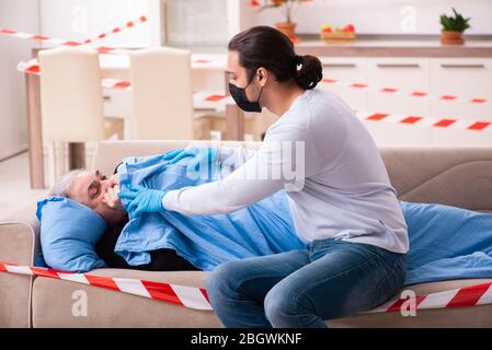 Father and son in the coronavirus concept at home Stock Photo