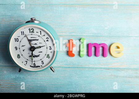 Time word formed with colorful letters on wooden background Stock Photo