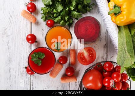 Vegetable juice and fresh vegetables  on wooden background Stock Photo