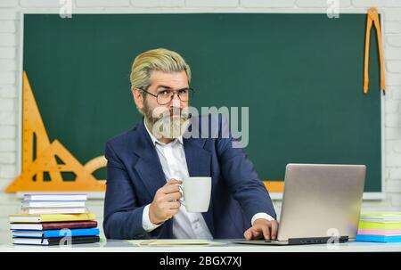 Teacher teaching programming language. Teacher at classroom. Watch ...