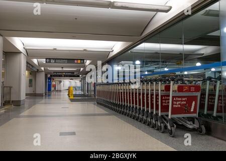 Baggage carts inside an empty terminal tunnel outside a parking garage at Toronto Pearson International Airport. Stock Photo
