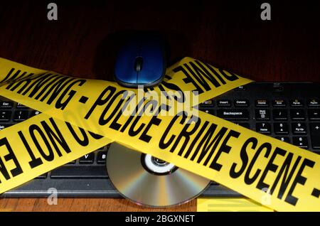 Yellow Police Crime Scene tape across a staged cybercrime scene Stock Photo