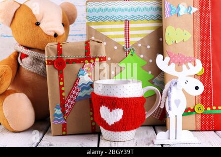 Hand-made Christmas gifts with decorations on wooden background Stock Photo