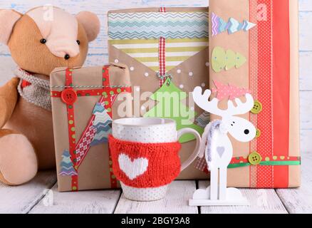 Hand-made Christmas gifts with decorations on wooden background Stock Photo