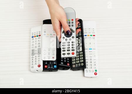 Many remote control devices on table Stock Photo