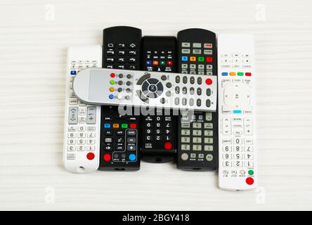 Many remote control devices on table Stock Photo