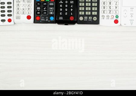 Many remote control devices on table Stock Photo