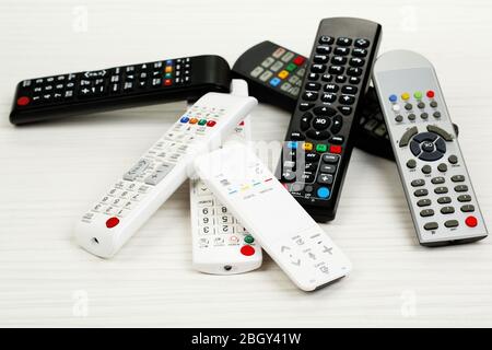 Many remote control devices on table Stock Photo