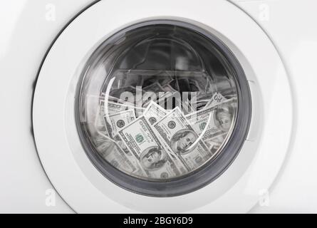 Money in washing machine, closeup view Stock Photo