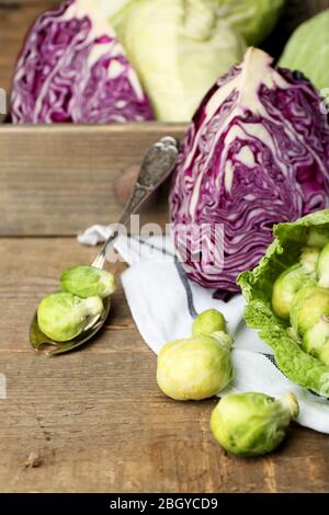 Still life with assortment cabbages on wooden background Stock Photo