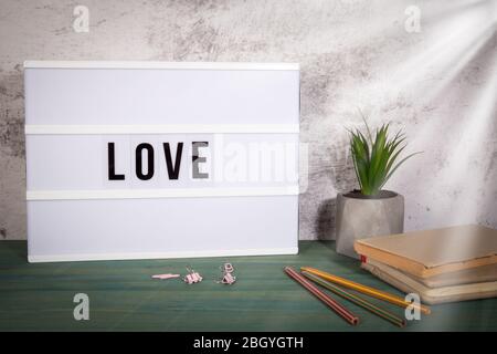 Love. Relationships, family, holidays and gratitude concept. White lightbox on a wooden table Stock Photo