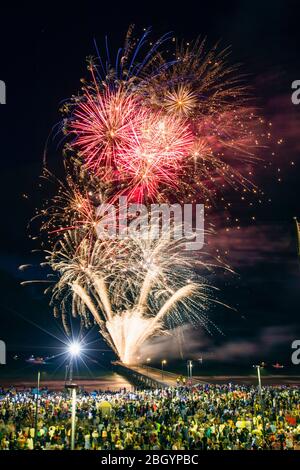 A large crowd watches the fireworks display at New Years Eve celebrations in Glenelg, South Australia Stock Photo