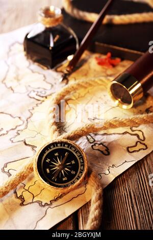 Marine still life spyglass and world map on wooden background Stock Photo