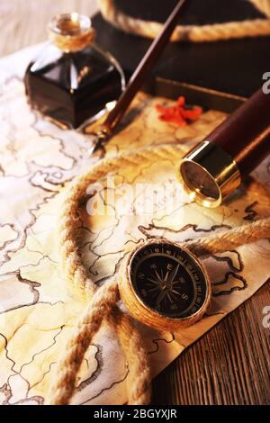 Marine still life spyglass and world map on wooden background Stock Photo