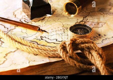 Marine still life with world map and rope on wooden table background Stock Photo