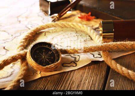 Marine still life spyglass and world map on wooden background Stock Photo
