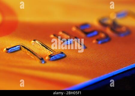 Numbers on plastic card on wooden table, macro view Stock Photo