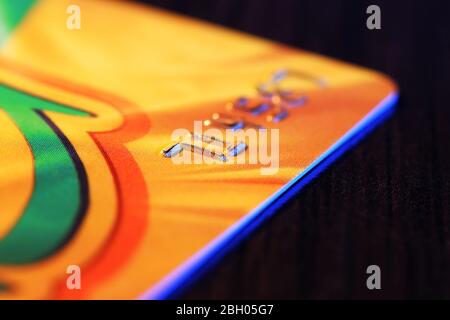 Numbers on plastic card on wooden table, macro view Stock Photo