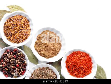 Different kinds of spices in ceramics bowls isolated on white Stock Photo