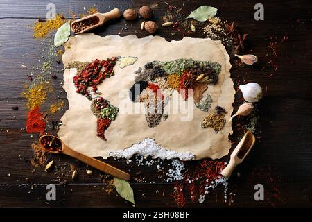 Map of world made from different kinds of spices on wooden background Stock Photo
