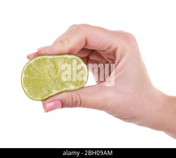 Female hand squeezing lime isolated on white Stock Photo