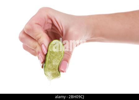 Female hand squeezing lime isolated on white Stock Photo