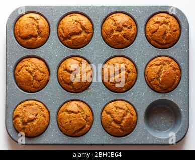 Carrot muffins in metal baking form. Homemade tasty dessert or breakfast. Healthy eating concept. Top view Stock Photo