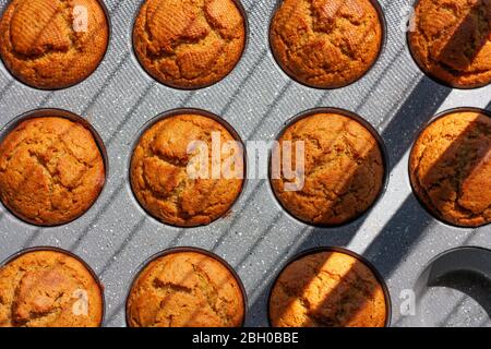 Carrot muffins in metal baking form. Homemade tasty dessert or breakfast. Healthy eating concept. Top view Stock Photo