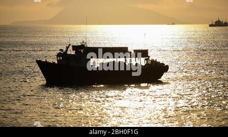 Beijing, China. 20th Apr, 2020. Photo taken on April 20, 2020 from Wailingding island shows boats on the sea during sunset in Zhuhai, south China's Guangdong Province. Credit: Deng Hua/Xinhua/Alamy Live News Stock Photo