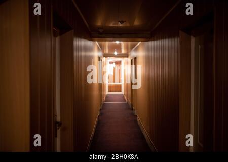 Corridor in a small hotel with brown walls. Stock Photo