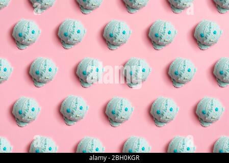Seamless pattern of balls of natural blue ice cream on a pink background Stock Photo