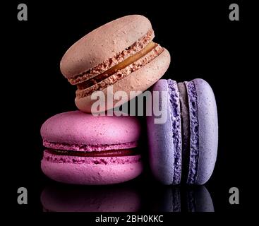 Heap of colorful macaroons on black Stock Photo